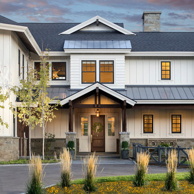 Inspiration for a country white two-story exterior home remodel in Salt Lake City with a mixed material roof