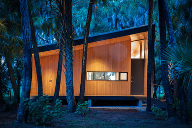 Small danish multicolored one-story metal house exterior photo in Other with a shed roof, a metal roof and a gray roof