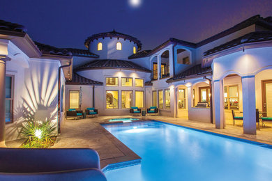 Large trendy white two-story stucco house exterior photo in San Diego with a hip roof and a tile roof