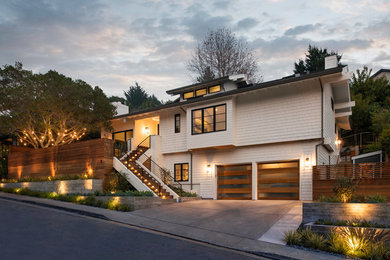 Large transitional white two-story mixed siding exterior home photo in San Francisco with a shingle roof