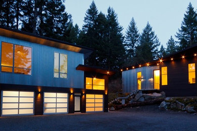 Example of a huge trendy blue two-story exterior home design in Vancouver