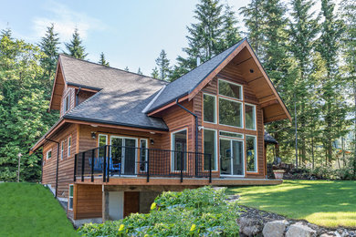 Mountain style two-story wood exterior home photo in Vancouver