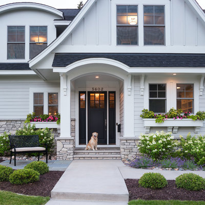 Large elegant white two-story concrete fiberboard gable roof photo in Minneapolis