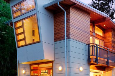 Inspiration for a large contemporary gray two-story concrete flat roof remodel in Seattle