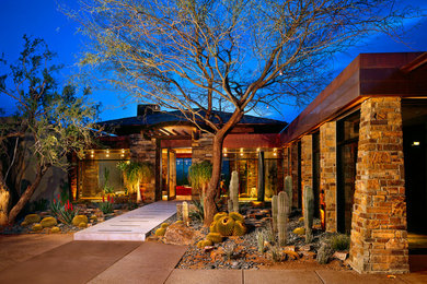 Inspiration for a huge southwestern beige two-story mixed siding exterior home remodel in Phoenix
