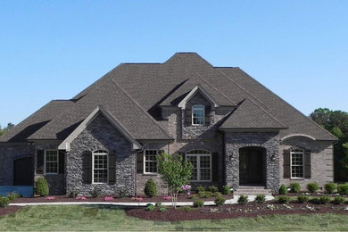 Large traditional gray two-story mixed siding exterior home idea in Raleigh with a clipped gable roof
