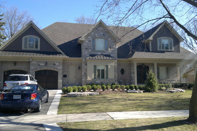 Photo of a large and beige classic two floor house exterior in Toronto with stone cladding.