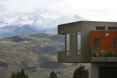 Inspiration for a contemporary brown two-story mixed siding flat roof remodel in Denver