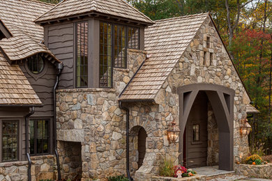 Inspiration for a large rustic brown two-story mixed siding gable roof remodel in Other