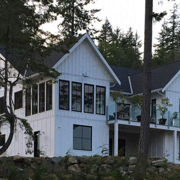 Transitional Oceanview Home: Black Windows, White Siding & Limestone Accents