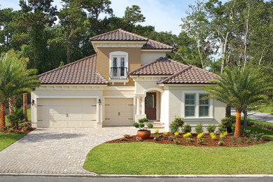 Mid-sized mediterranean beige two-story stucco gable roof idea in Jacksonville