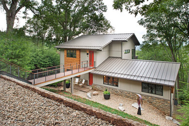 Стильный дизайн: двухэтажный, серый дом среднего размера в стиле модернизм с двускатной крышей - последний тренд