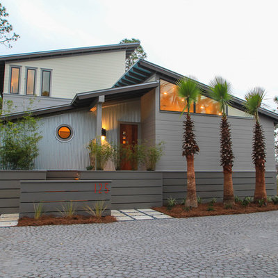 Contemporary gray two-story mixed siding exterior home idea in Miami with a shed roof