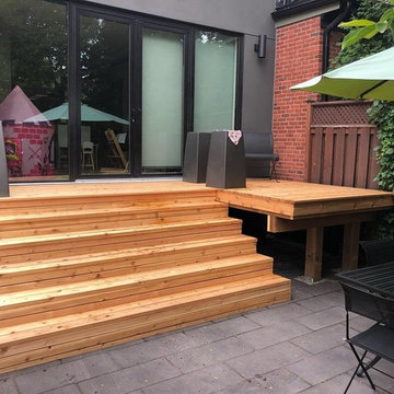 Modern Backyard Patio with Cedar Deck and Stone Patio in Toronto