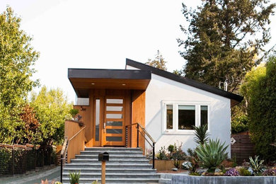 Trendy white one-story mixed siding house exterior photo in San Francisco with a shed roof