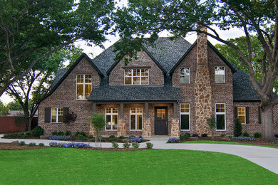 Inspiration for a large timeless brown two-story brick exterior home remodel in Dallas