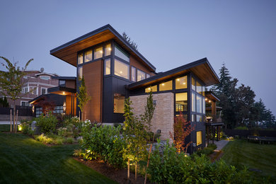 Inspiration for a huge contemporary black three-story mixed siding exterior home remodel in Seattle