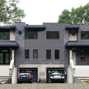 Ispirazione per la facciata di una casa bifamiliare grande nera contemporanea a due piani con rivestimento in pietra