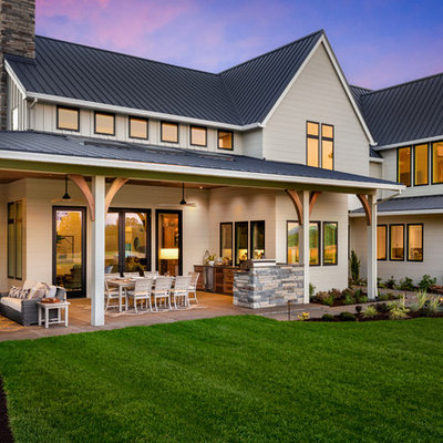 Inspiration for a huge farmhouse gray two-story wood exterior home remodel in Portland with a metal roof