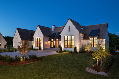Inspiration for a huge transitional white two-story stucco exterior home remodel in Minneapolis with a shingle roof