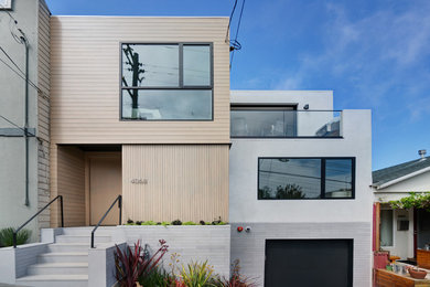 This is an example of a large and gey contemporary render detached house in San Francisco with three floors.