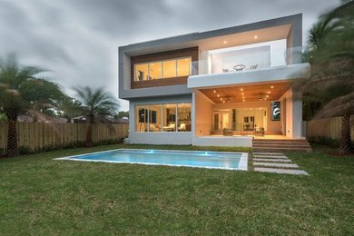 Inspiration for a large contemporary gray two-story concrete exterior home remodel in Miami