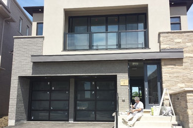 Contemporary gray two-story exterior home idea in Toronto