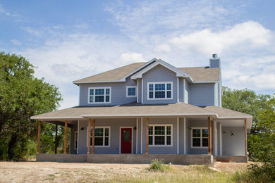 Example of a country blue two-story exterior home design in Austin