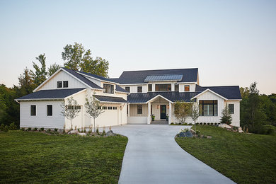 Example of a large farmhouse white two-story concrete fiberboard gable roof design in Grand Rapids