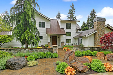 Inspiration for a cottage white three-story exterior home remodel in Seattle with a metal roof