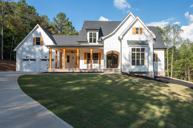 Large country white three-story wood house exterior photo in Atlanta with a hip roof and a shingle roof