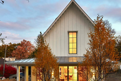 Country white house exterior idea in Minneapolis with a metal roof