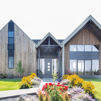 Inspiration for a large modern three-story wood exterior home remodel in Seattle with a metal roof