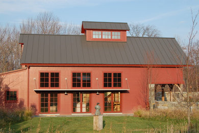 Design ideas for a large and red farmhouse two floor house exterior in Boston with wood cladding and a pitched roof.