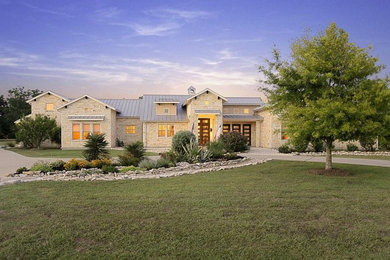 Mid-sized cottage white one-story stone exterior home idea in Houston with a metal roof