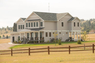 Inspiration for a mid-sized country gray two-story wood exterior home remodel in Other with a shingle roof