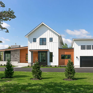 Mid-sized cottage white two-story mixed siding house exterior idea in Philadelphia with a shed roof and a shingle roof