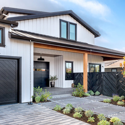 Large cottage white two-story concrete fiberboard gable roof photo in San Francisco