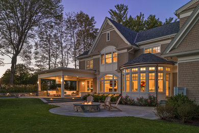 Traditional beige two-story wood exterior home idea in Boston with a shingle roof