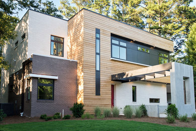 Inspiration for a mid-sized modern two-story brick flat roof remodel in Atlanta
