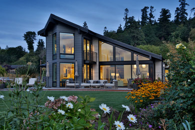 Large minimalist gray two-story mixed siding exterior home photo in Seattle with a metal roof