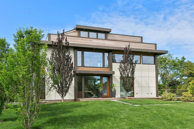 Imagen de fachada de casa multicolor moderna de tamaño medio de tres plantas con revestimientos combinados, tejado plano y tejado de varios materiales