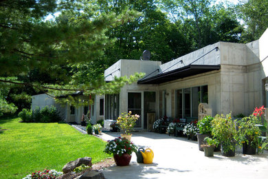Inspiration for a large industrial gray concrete exterior home remodel in Columbus