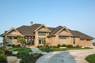 Example of a large trendy beige two-story concrete fiberboard exterior home design in Omaha with a hip roof