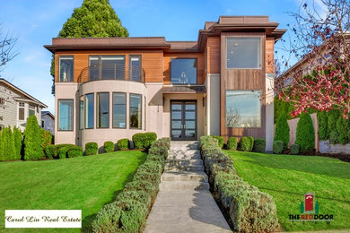 Example of a large trendy beige two-story exterior home design in Seattle