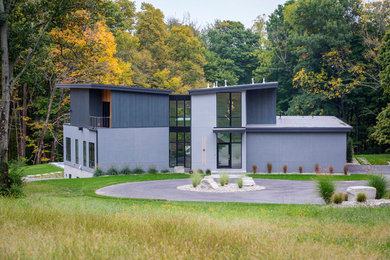 Inspiration for a large modern gray two-story mixed siding exterior home remodel in Cincinnati with a mixed material roof