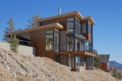 Inspiration for a small modern three-story metal exterior home remodel in Denver with a shed roof