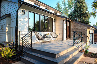 This is an example of a white modern house exterior in Denver with mixed cladding, a lean-to roof and a shingle roof.