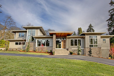 Example of a large trendy beige two-story mixed siding exterior home design in Portland with a shingle roof