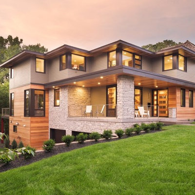 Huge minimalist gray two-story mixed siding house exterior photo in Minneapolis with a hip roof and a mixed material roof